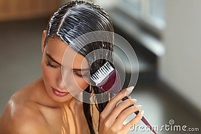 Hair Masks. Woman Applying Mask With Brush On Wet Long Hair Stock Photo