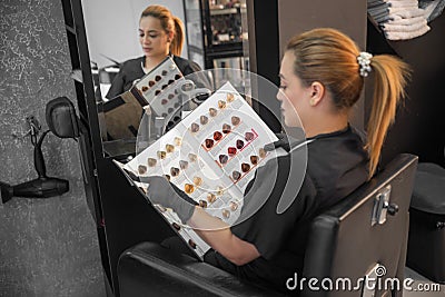 Professional hair colorist woman choosing color and tones in beauty salon Stock Photo