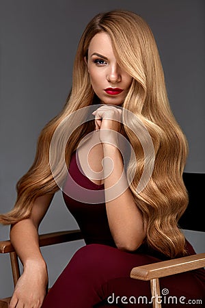 Hair Style. Beautiful Woman With Healthy Wavy Long Blonde Hair Stock Photo