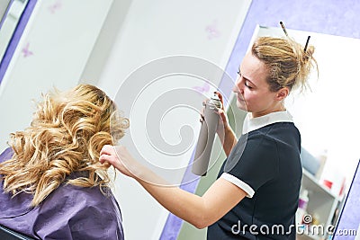 Hairdo in beauty salon. hairdresser fixing hair with hairspray Stock Photo