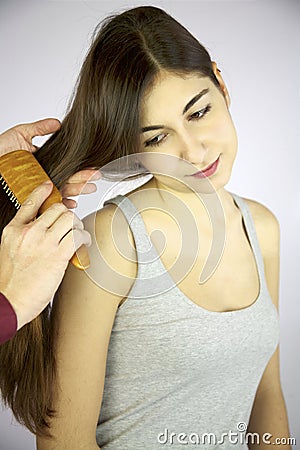 Brushing long silky blonde hair for boys