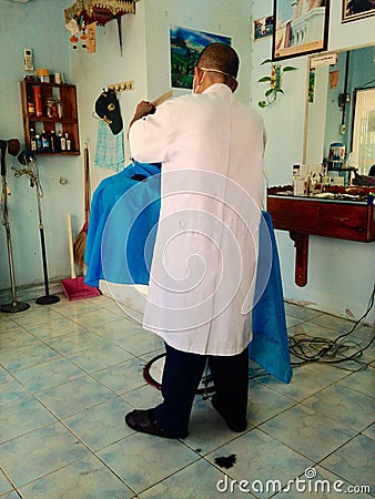 Hairdresser cutting man Editorial Stock Photo