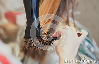 Hairdresser dries hair the girl blonde Stock Photo