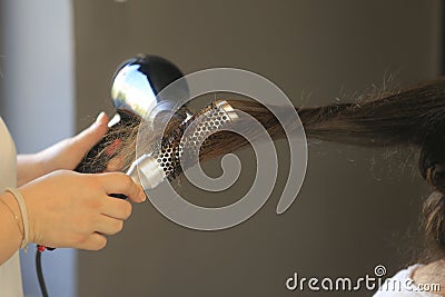 Hairdresser dries the hair Stock Photo