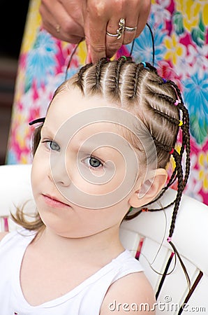 Hairdresser hands weaving a dreadlocks. Stock Photo