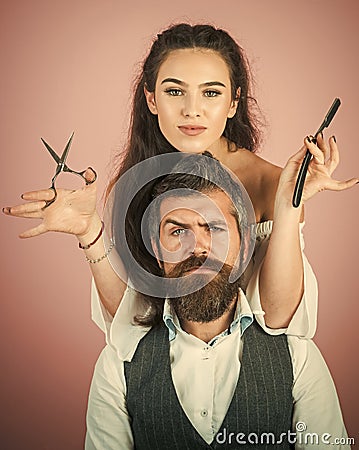Hairdresser shears the client in the hairdresser. Happy positive woman and bearded man, hairdresser Stock Photo