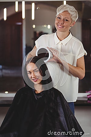 Hairdresser showing woman her haircut in mirror Stock Photo