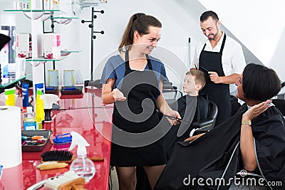 Hairdresser talking with client in beauty salon Stock Photo