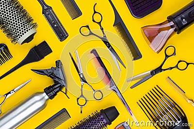 Hairdresser tools and combs tools on yellow background, top view Stock Photo