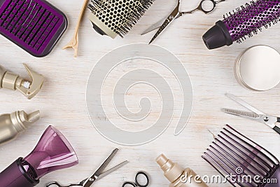 Hairdresser tools on wooden background with copy space in center Stock Photo