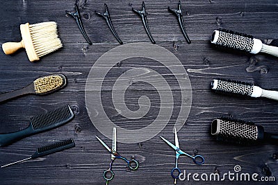 Hairdresser tools on wooden background. Top view on wooden table with scissors, comb, hairbrushes and hairclips, free space. Stock Photo