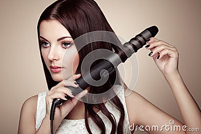 Hairdresser woman curls her hair Stock Photo