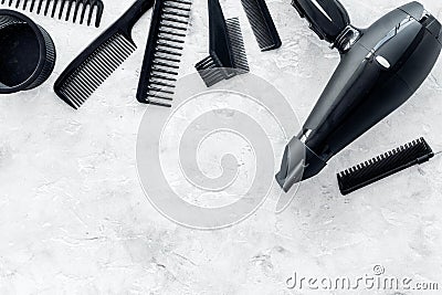 Hairdresser working desk with dryer and tools for hair styling on gray stone desk background top view mock up Stock Photo