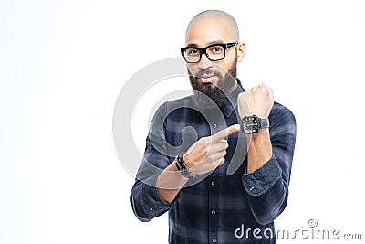 Hairless african man in glasses with beard pointing on watch Stock Photo