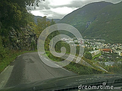 Hairpin curve on a steep road photographed from inside a car through the front window. Stock Photo