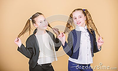 Hairstyle for female. Cheerful friends made same hairstyle for fun. We look like sisters. Best friends forever. Long Stock Photo