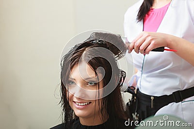 Hairstylist drying hair woman client in hairdressing beauty salon Stock Photo