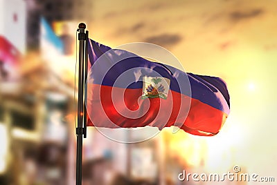 Haiti Flag Against City Blurred Background At Sunrise Backlight Stock Photo