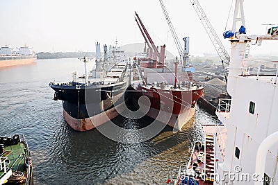 Haldia, India, October, 27, 2020. Seagoing vessels, tugboats at the port under cargo operations and underway. Editorial Stock Photo