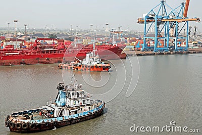 Haldia, India, October, 27, 2020. Seagoing vessels, tugboats at the port under cargo operations and underway. Editorial Stock Photo