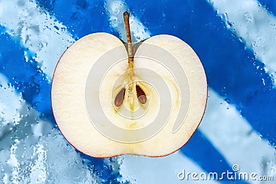 Half an apple on a blue background Stock Photo