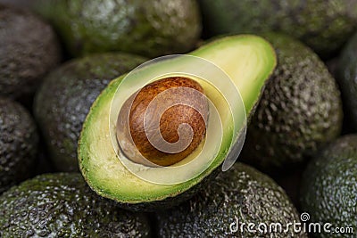 Half avocado over other avocados Stock Photo