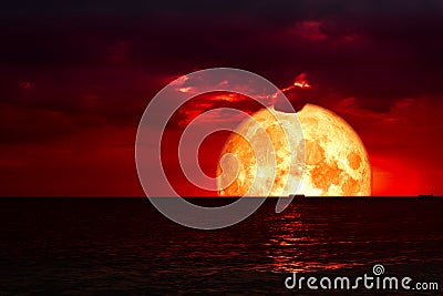 half blood moon on night sea and back silhouette red cloud Stock Photo