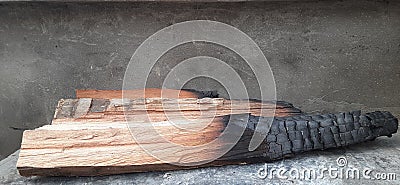 Half burned Melia azedarach tree wood log Stock Photo