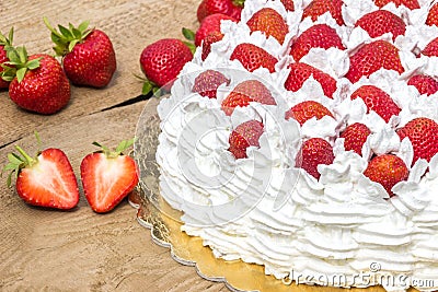 Half cake with strawberries summery cake. Stock Photo