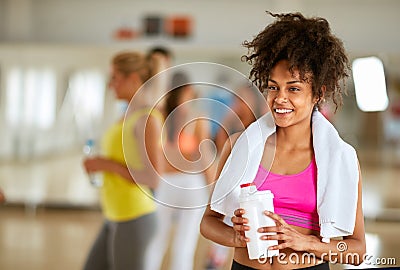 Half-caste female refreshing with protein shake Stock Photo