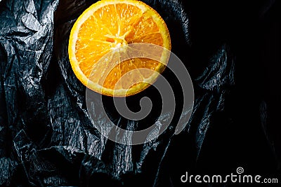 Half an orange on a dark background Stock Photo