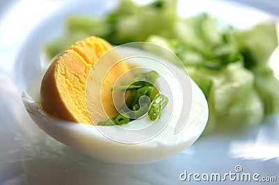 Half an egg with green onions, chopped egg, vegetable salad. Macro yellow yolk, white egg white, chopped onion. Useful breakfast, Stock Photo