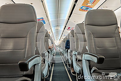 Half empty cabin of a passenger plane. Empty seats for passengers. Airplane interior Editorial Stock Photo