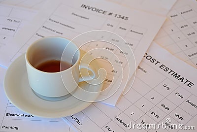 Half Empty Cup of Tea on Financial Documents Stock Photo