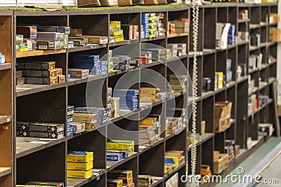 Half empty shelves with rifle and pistol ammo boxes at a gun shop, ammunition shortage in California, USA Editorial Stock Photo