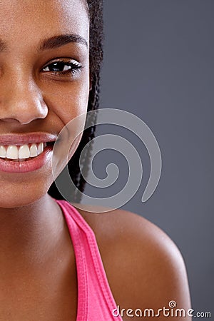 Half face of young African smiling girl, close up Stock Photo