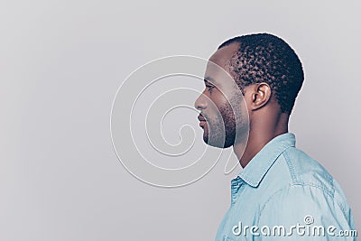 Half-faced side profile view portrait of thoughtful pensive serious confident handsome guy dressed in light blue shirt, isolated Stock Photo