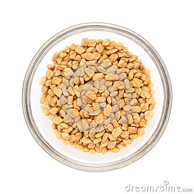 Half filled bowl of Organic Fenugreek. Stock Photo