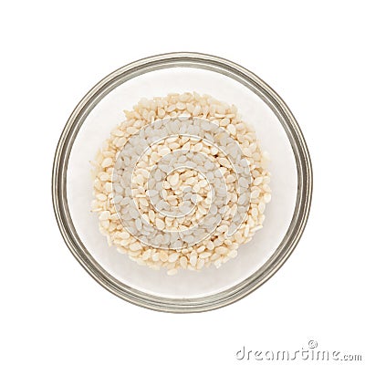 Half filled bowl of Organic Sesame white. Stock Photo