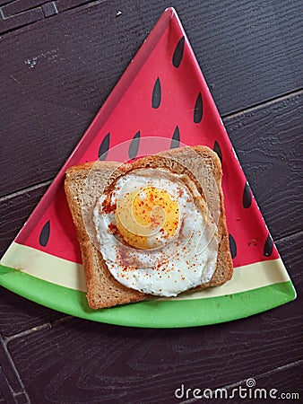 Half frie egg with bread Stock Photo