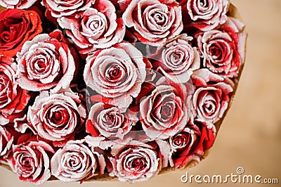 Half image of round romantic bouquet of red pion-shaped roses decorated with white powder Stock Photo