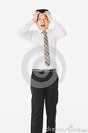 Half-length portrait of middle aged, handsome, Asian, businessman, in white shirt, striped tie.suffer from acute migraine, grimace Stock Photo