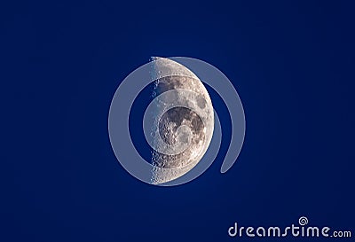 Half moon in blue night sky Stock Photo