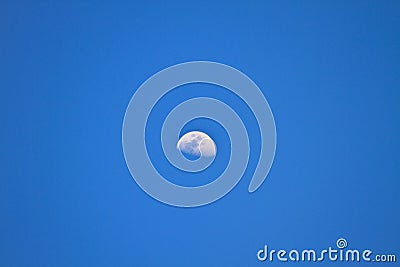 Half moon in blue sky Stock Photo