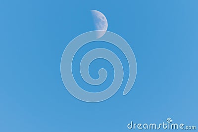 Half moon on a clear blue sky Stock Photo