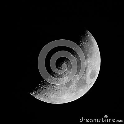 Half Moon with craters on black sky background Stock Photo