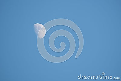 Half moon in daytime sky Stock Photo