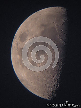 Half moon seen through a small telescope Stock Photo