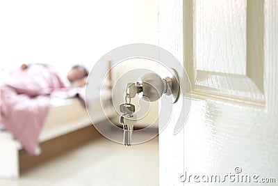 Half opened bedroom door which have someone sleeping Stock Photo