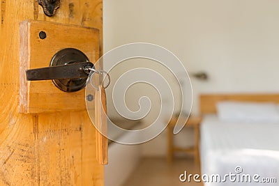 Half opened door of a bed room, key in keyhole Stock Photo